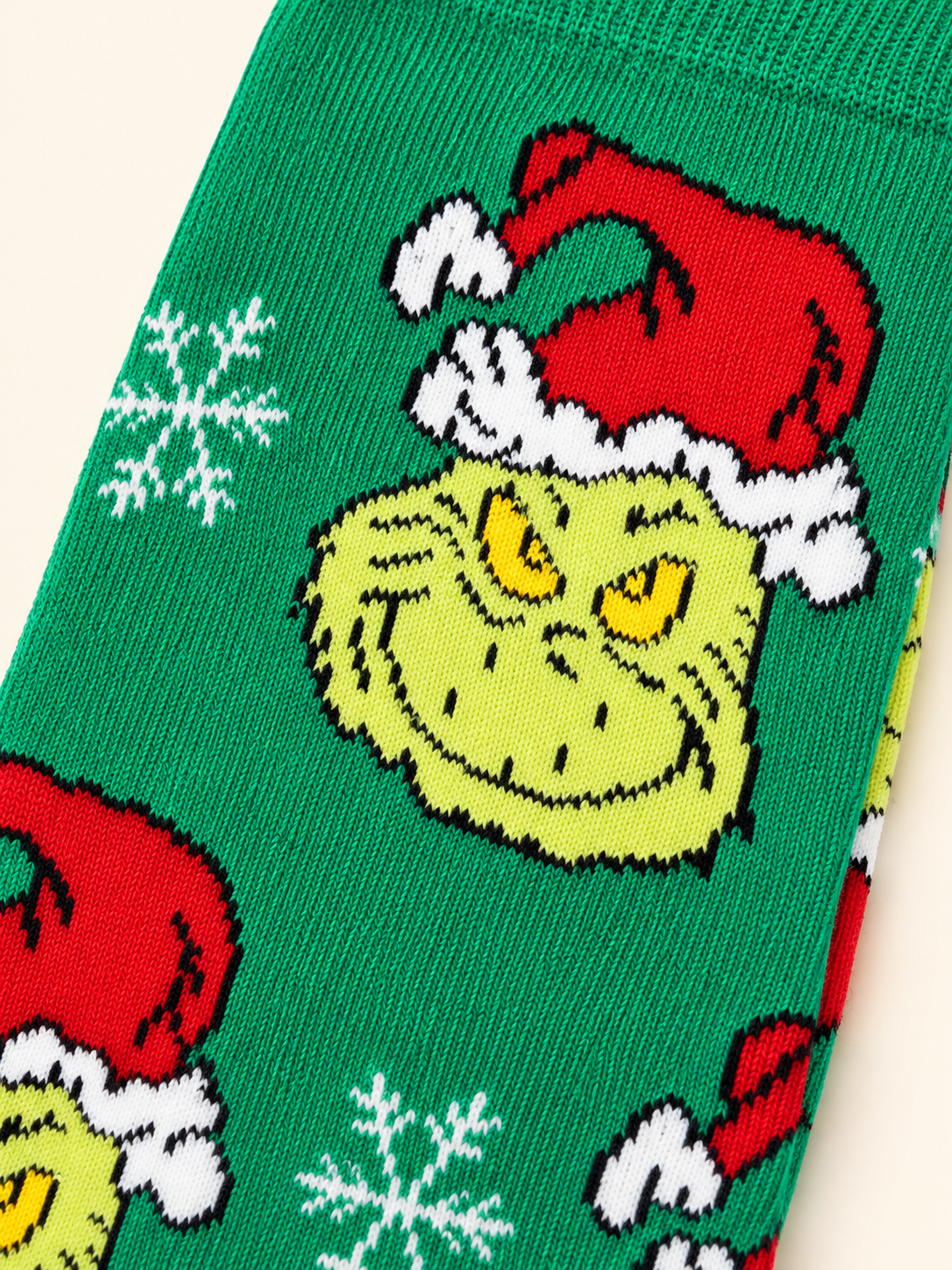 Medias Grinch Christmas para caballero, talla 6–12. Detalle del tejido.